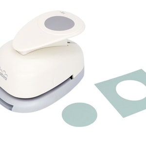 May include: A white and gray circle punch with the brand name "birabira" printed on the side. The punch is used to create circles in paper. The image also shows a sample of a circle punched out of a light blue piece of paper.