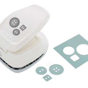 May include: A white button-shaped paper punch with grey button-shaped accents. The punch is open, revealing the cutting area. A light blue paper with button-shaped cutouts and three light blue button shapes are also present.