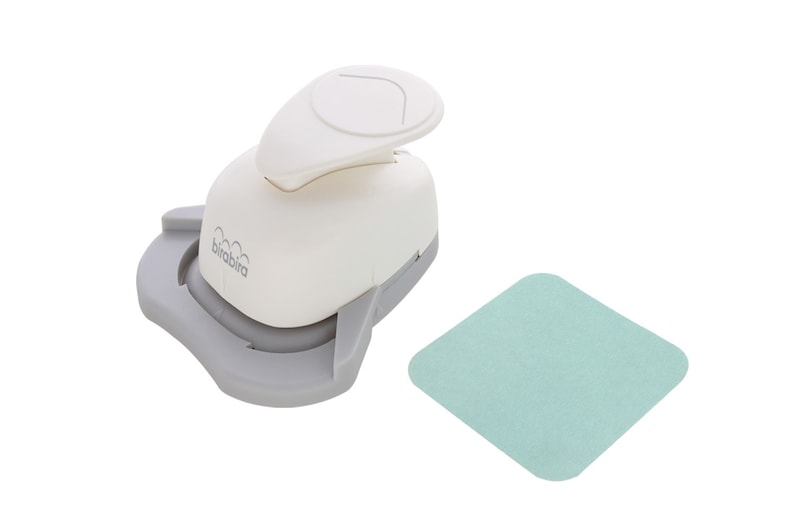 May include: White paper punch with a grey base and a light blue mat. The punch is labelled "birabira".