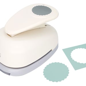 May include: A white paper punch with a scalloped circle design. The punch is on a white background with two samples of the punched design in light blue.