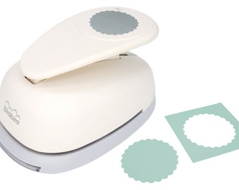 May include: White paper punch with a gray scalloped circle design. The punch is on a white background with two samples of the punched design in light green.