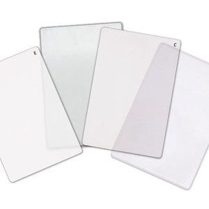 May include: Four white cutting mats of different sizes, labelled A, B, C, and E. The mats are made of a durable, non-slip material and are ideal for protecting your work surface.