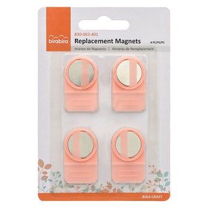 May include: Package of four pink replacement magnets for a magnetic whiteboard. The package says "Replacement Magnets" and "830-003-401".