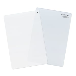 May include: Two clear plastic cutting mats, one with the text "CUTTING MAT" and "IDEAL FOR STEEL RULE DIE CUTTING/CRAFTING" printed on it.