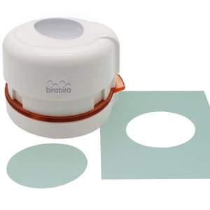 May include: White circle punch with an orange base and the word "birabira" printed on it. The punch is used to create circles in paper. Two samples of circles are shown, one on a white surface and one on a light green surface.