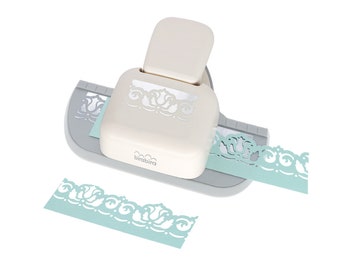 May include: A white and gray paper border punch with a light blue border design. The punch is made by the brand "birabibra".