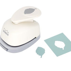 May include: White paper punch with a grey leaf design on the top. The punch is on a white background with a grey leaf cutout and a smaller grey leaf cutout.
