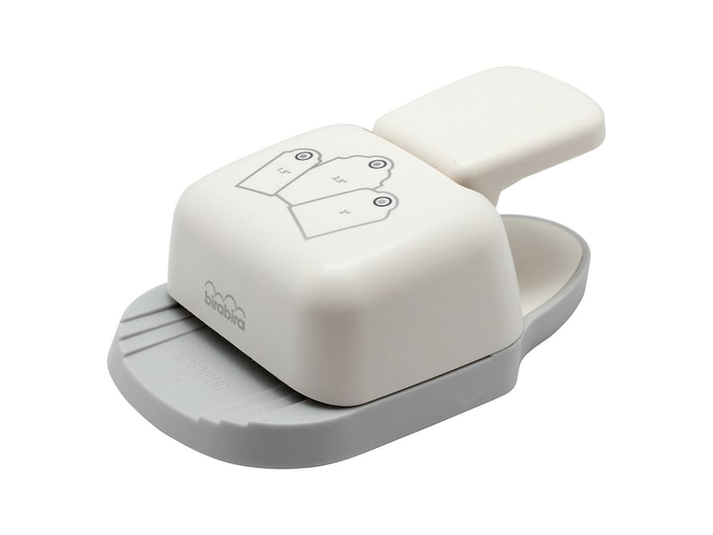 May include: White and grey paper punch with a handle. The punch is designed to create three different sized tags. The punch is labelled "brabbra".