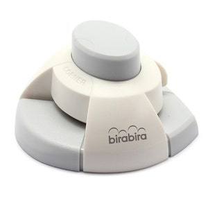 May include: White corner rounder with a gray base and a gray button. The corner rounder has the word "corner" and the brand name "birabira" printed on it.