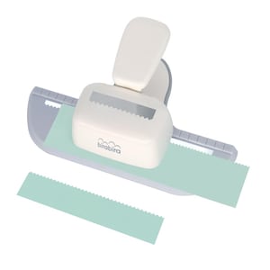 May include: A white paper punch with a lever, designed to create a decorative edge. The punch is shown with a light green paper strip and a cut-out piece. The brand name "birabira" is visible on the punch.