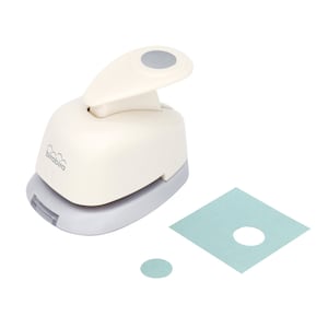 May include: A white and gray paper punch with a gray handle and a gray circle on the top. The punch is used to create circles in paper. A sample circle is shown next to the punch.