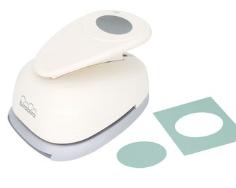 May include: White circle punch with a gray handle and a gray circle on the top. The punch is next to a light green circle and a light green square with a circle cut out.