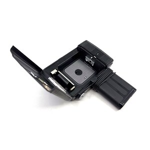 May include: A black and silver camera with the back open, revealing the film compartment and battery slot.