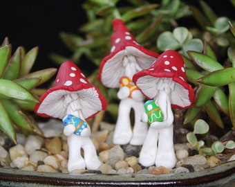 Sculpted, clay Easter Mushrooms gathering easter eggs for your miniature gardens