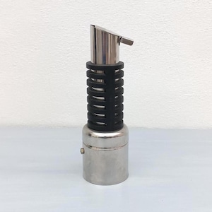 May include: A stainless steel oil or vinegar pourer with a black rubber grip and a hinged spout. The pourer has a cylindrical shape with a small button on the base. The design is modern and sleek.