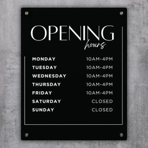 May include: Black and white sign with the text "OPENING hours" and a list of daily hours of operation. Monday to Friday, the store is open from 10 AM to 4 PM. Saturday and Sunday, the store is closed.