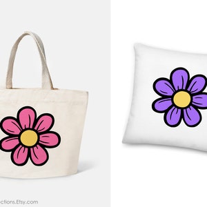 May include: A tote bag and a cushion featuring a simple cartoon flower design. The flower is pink with a yellow centre on the tote bag and purple with a yellow centre on the cushion.