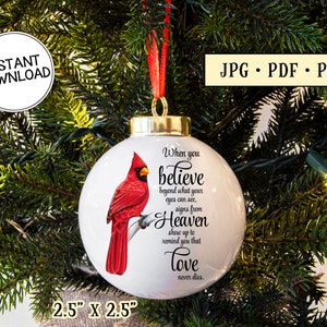 May include: White Christmas bauble featuring a red cardinal bird illustration and the text "When you believe...love never dies." The bauble is 6.35 cm x 6.35 cm and has a red ribbon. The image also includes "Instant Download" and file type information.