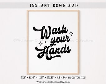 May include: A framed print with the words "Wash your Hands" in black script. The print includes decorative star shapes and the text "INSTANT DOWNLOAD". The frame is a light wood color. The print is available in various sizes.