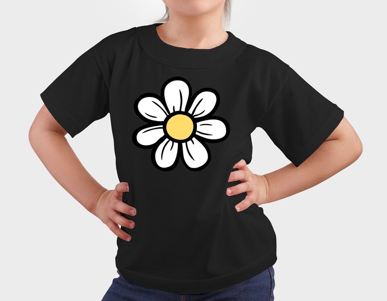 May include: A black t-shirt featuring a white daisy graphic. The daisy has a yellow centre.