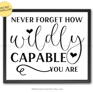 May include: A framed print with the text "NEVER FORGET HOW wildly CAPABLE YOU ARE" in black script on a white background. A yellow circle with "INSTANT DOWNLOAD" is in the upper left corner. The Etsy shop name is at the bottom.