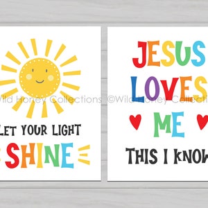 May include: Two printable wall art prints with a white background. The left print features a yellow sun with a smiling face and the text "Let your light shine" in rainbow colors. The right print features the text "Jesus loves me this I know" in rainbow colors with two red hearts.