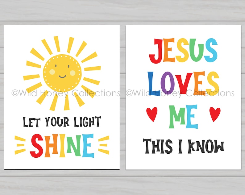 May include: Two printable wall art prints with a white background. The left print features a yellow sun with a smiling face and the text "Let your light shine" in rainbow colors. The right print features the text "Jesus loves me this I know" in rainbow colors with two red hearts.