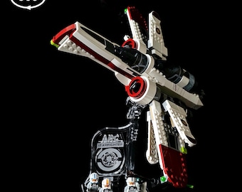 May include: A white, red, and black LEGO Star Wars ARC-170 Starfighter with three minifigures on a clear display stand. The stand has the text "ARC STARFIGHTER" on it. The set number 75402 is visible in the top right corner of the image.