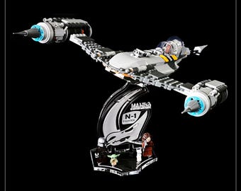 May include: A white and grey LEGO Star Wars N-1 Starfighter with a clear display stand. The stand features the text "MANO N-1 FIGHTER". The ship is on a black background.