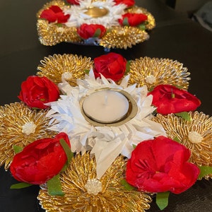 Decorated Diya stand surrounded by  flower design. Used for return gifts also.