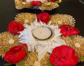 Decorated Diya stand surrounded by  flower design. Used for return gifts also.