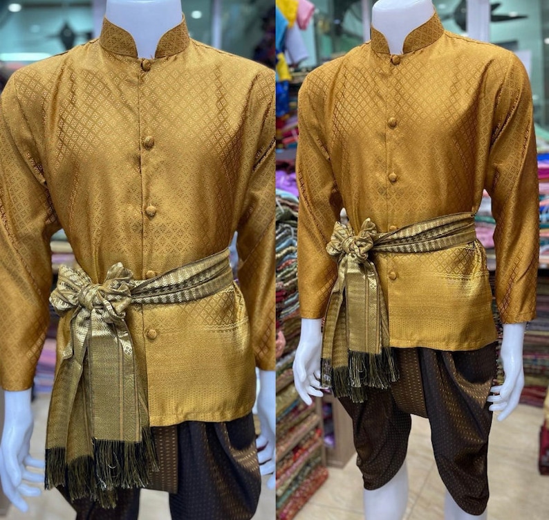 May include: A gold long-sleeved shirt with a patterned design and a matching pair of pants. The shirt has a mandarin collar and a button-up front. The pants are a traditional style with a wide leg.