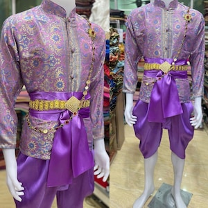 May include: A purple and gold patterned shirt with a matching purple sash and pants. The shirt has a mandarin collar and a gold chain with coin accents. The sash is tied in a bow at the waist and the pants are loose fitting.