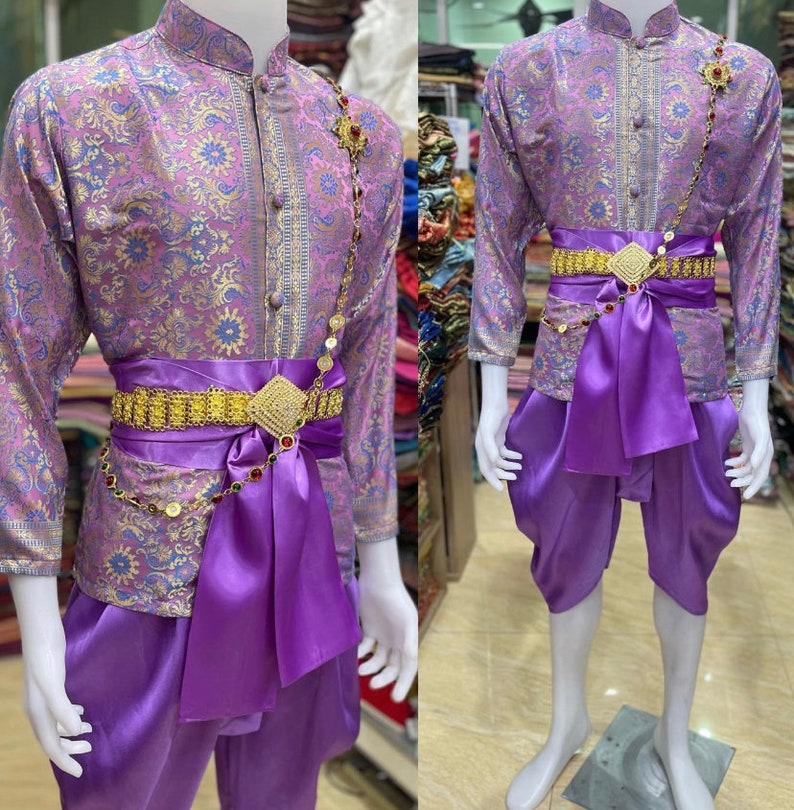 May include: A purple and gold patterned shirt with a matching purple sash and pants. The shirt has a mandarin collar and a gold chain with coin accents. The sash is tied in a bow at the waist and the pants are loose fitting.