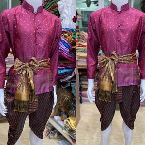 May include: A purple shirt with a white polka dot pattern and a gold sash. The shirt has a mandarin collar and a button-up front. The sash is tied in a bow at the waist. The shirt is worn over a pair of black and purple striped pants.