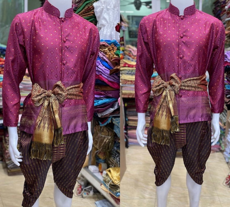 May include: A purple shirt with a white polka dot pattern and a gold sash. The shirt has a mandarin collar and a button-up front. The sash is tied in a bow at the waist. The shirt is worn over a pair of black and purple striped pants.