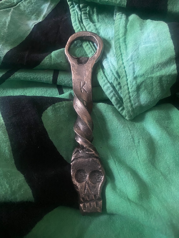 A skull forged in steel by a real blacksmith with 77 fans — spooky-cool bar tool that's Halloween-ready year-round.