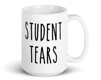 May include: White ceramic mug with black text that reads "STUDENT TEARS".