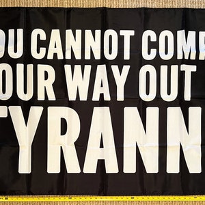 May include: Black flag with white text that reads "You cannot comply your way out of tyranny".
