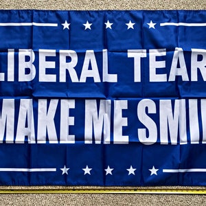 May include: A blue flag with white stars and white text that reads "LIBERAL TEARS MAKE ME SMILE".