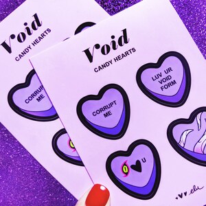 May include: A set of four purple and black heart-shaped stickers with different messages. The messages are "Corrupt Me", "Luv Ur Void Form", "0", and a heart with a black eye. The stickers are on a purple background with the text "Void Candy Hearts" at the top.