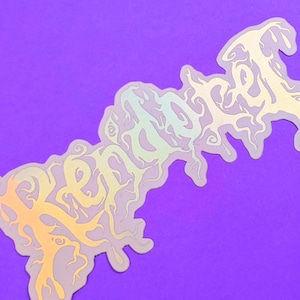 May include: A holographic sticker with the word "remarkable" written in a stylized, dripping font.