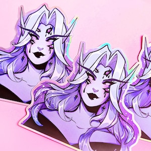 May include: Three holographic stickers featuring a purple-haired character with three eyes and a dark purple outfit. The character has a dark purple lipstick and a dark purple eyeshadow. The stickers have a glittery background.