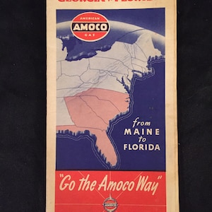 May include: A vintage travel map for the American Southeast, featuring a map of North Carolina, South Carolina, Georgia, and Florida. The map is titled "Go the Amoco Way" and features the Amoco gas logo. The map is from Maine to Florida.