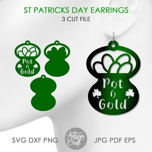 May include: Green and black St Patrick's Day earrings with a pot of gold design. The earrings are cut from a single piece of material and have a layered effect. The text "Pot o' Gold" is written on the earrings.