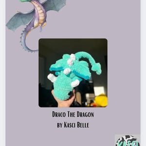 May include: A teal crocheted dragon plush toy named "Draco the Dragon" by Kasci Belle. The dragon has white accents and a curled tail.