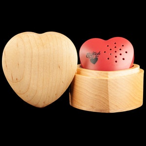 May include: A red heart-shaped music box with the words "Gifted from the heart" on the front. The music box is in a wooden heart-shaped box.