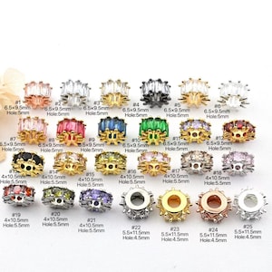 May include: A collection of 25 assorted jewelry beads in various colors and designs. The beads have different shapes and sizes, with some featuring rectangular crystal accents. Measurements are included for each bead, such as 6.5x9.5mm and 4x10.5mm.