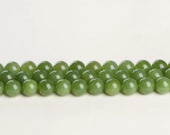 May include: A strand of round, green jade beads. The beads are smooth and polished, with a slight sheen.