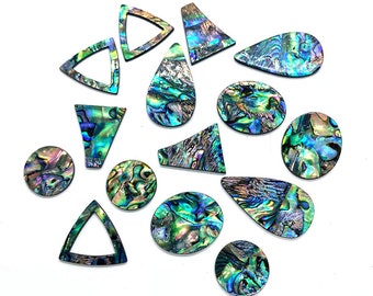 May include: Assortment of iridescent abalone shell inlay pieces in various shapes, including circles, teardrops, and triangles. The pieces are a mix of blue, green, and purple hues.